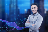 cheerful-asian-man-portrait-he-is-standing-with-his-arms-crossed-against-night-cityscape-with-blue-graphs-background-mock-up-double-exposure 1