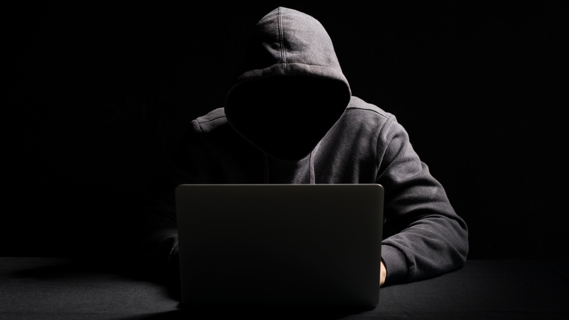 Hacker Working on Laptop in the Dark